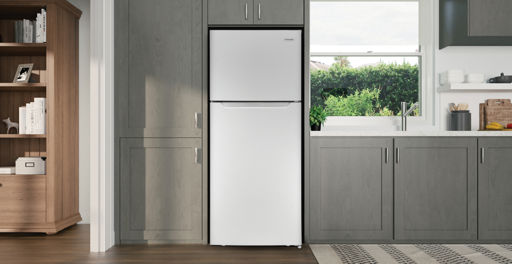 photo of a kitchen with a top freezer refrigerator built into the cabinets